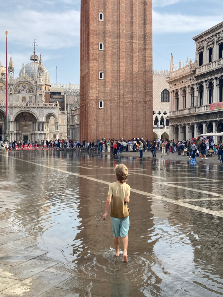 Flooded St Mark's Square in Venice with children